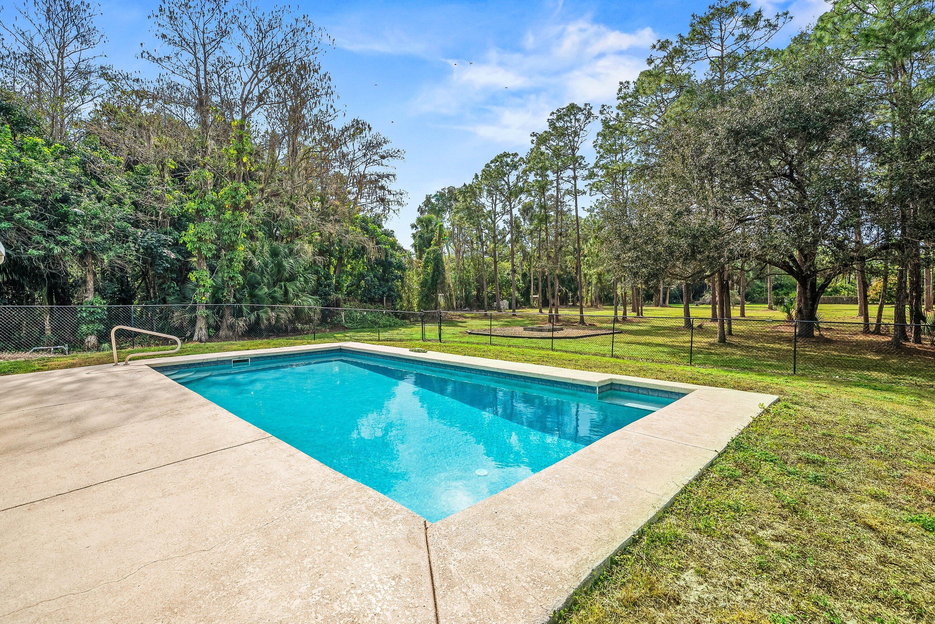2195 F Road Loxahatchee Groves, FL 33470 - Photo 26 of 54 a view of a swimming pool with a yard