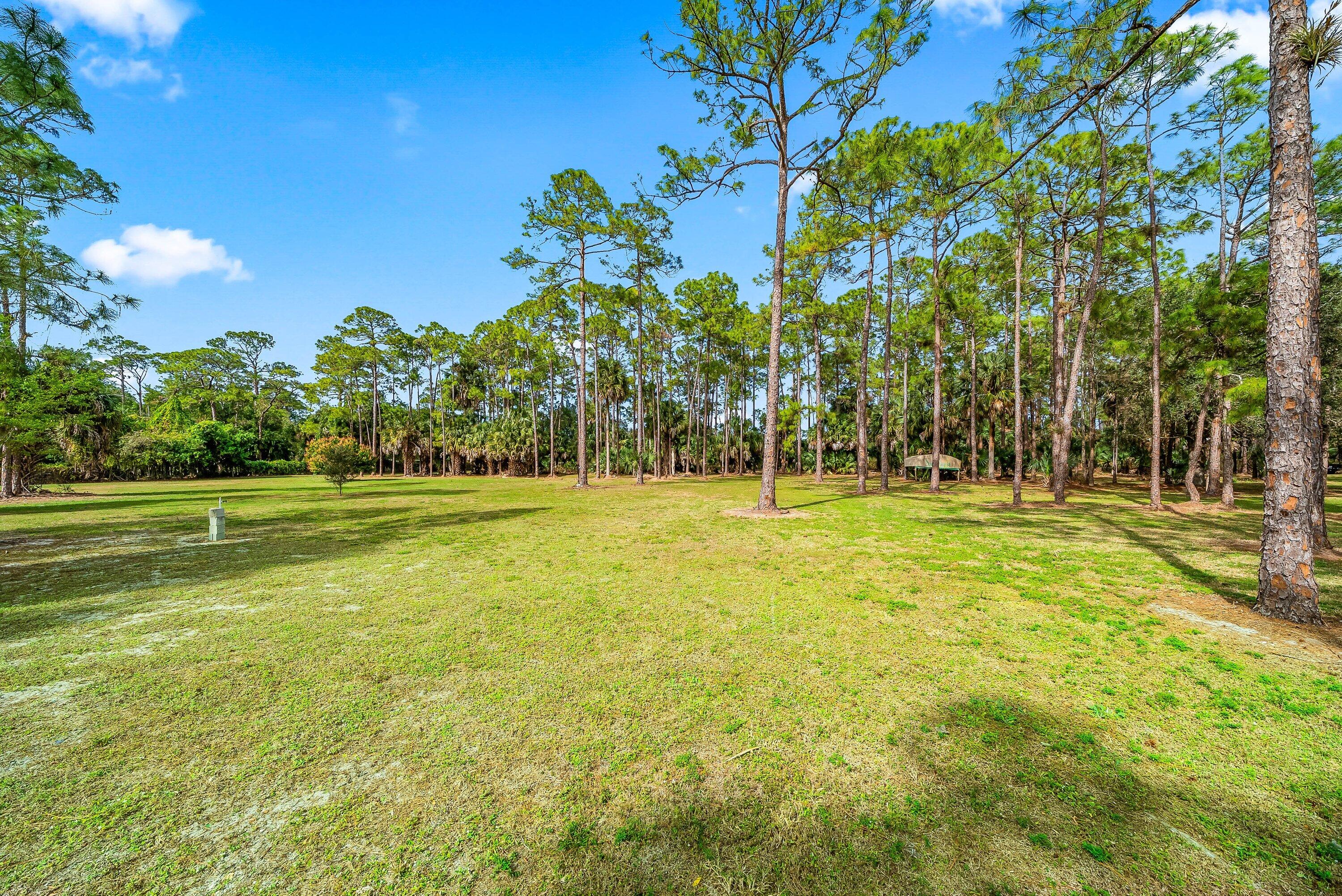 2195 F Road Loxahatchee Groves, FL 33470 - Photo 28 of 54 a view of swimming pool with an outdoor space and seating