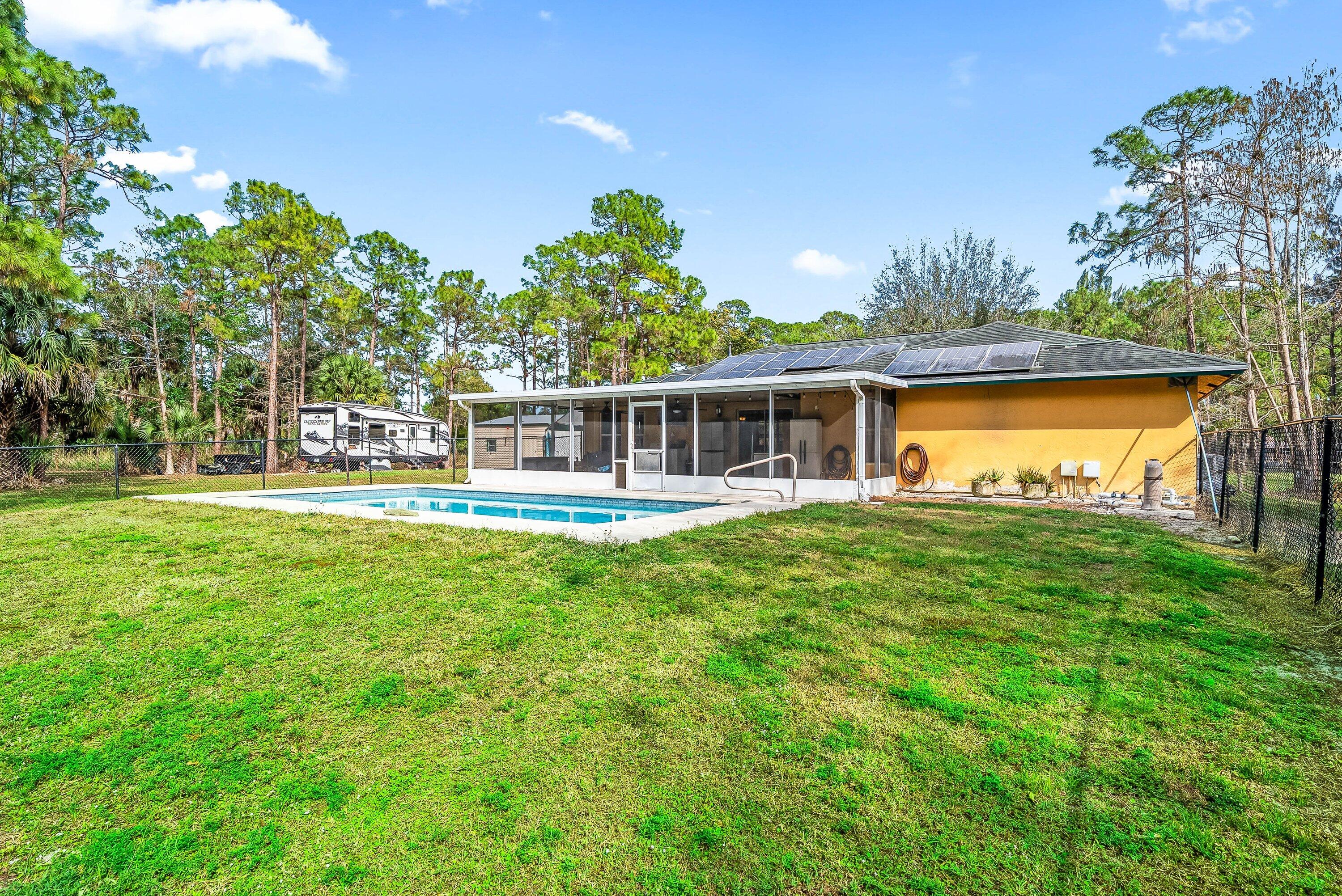 2195 F Road Loxahatchee Groves, FL 33470 - Photo 29 of 54 a view of a house with a backyard