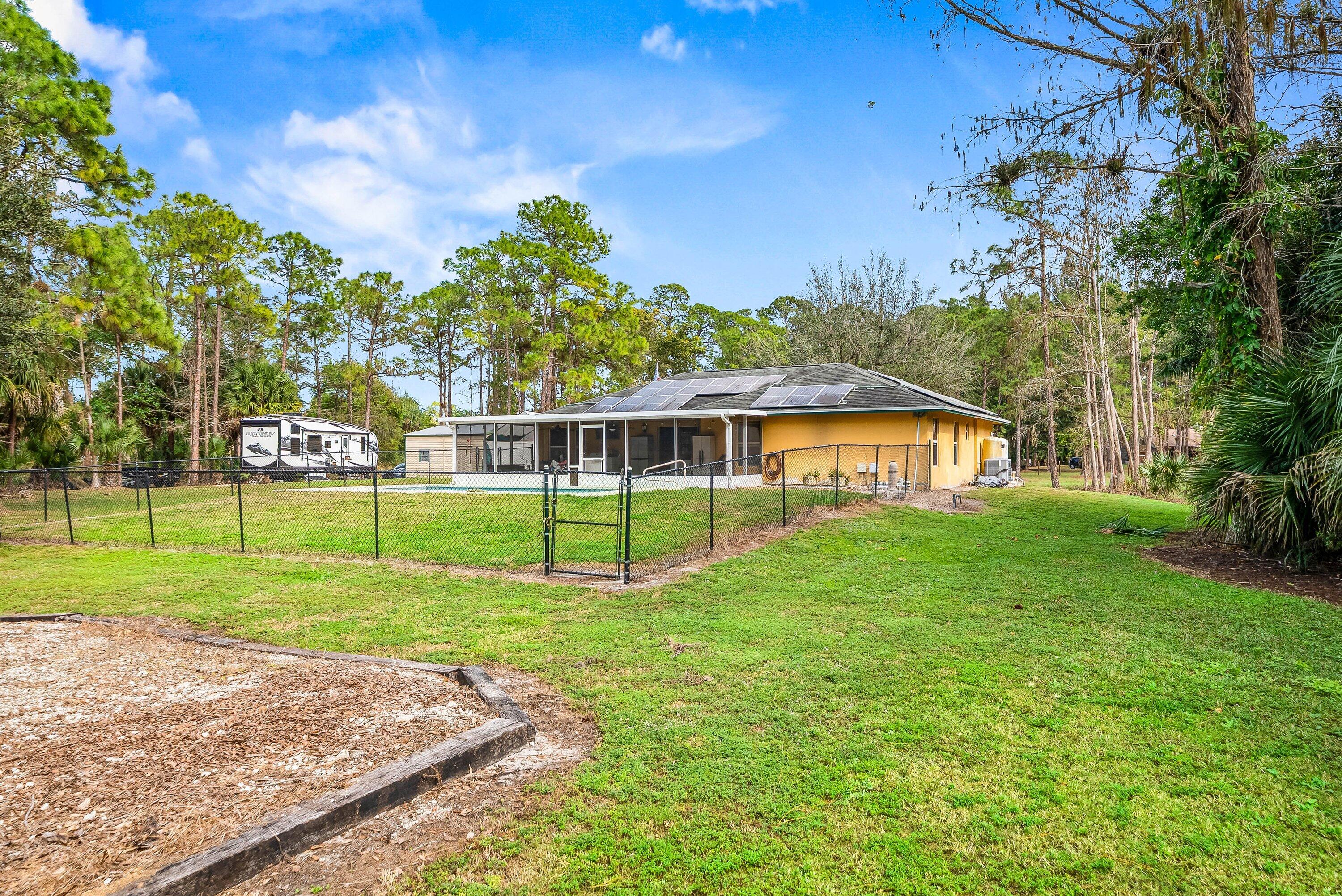 2195 F Road Loxahatchee Groves, FL 33470 - Photo 34 of 54 a view of a house with a big yard