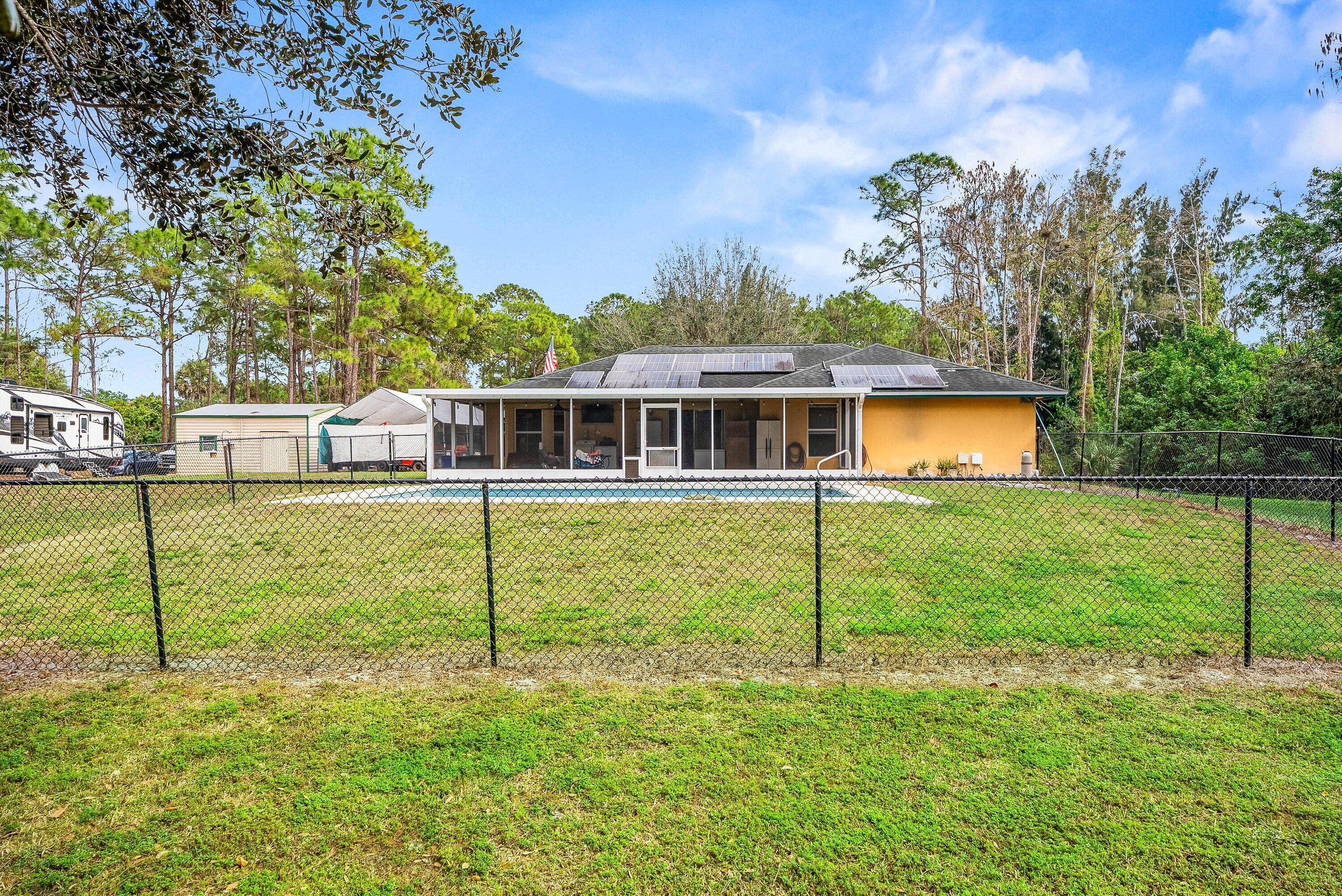 2195 F Road Loxahatchee Groves, FL 33470 - Photo 35 of 54 a view of a house with backyard