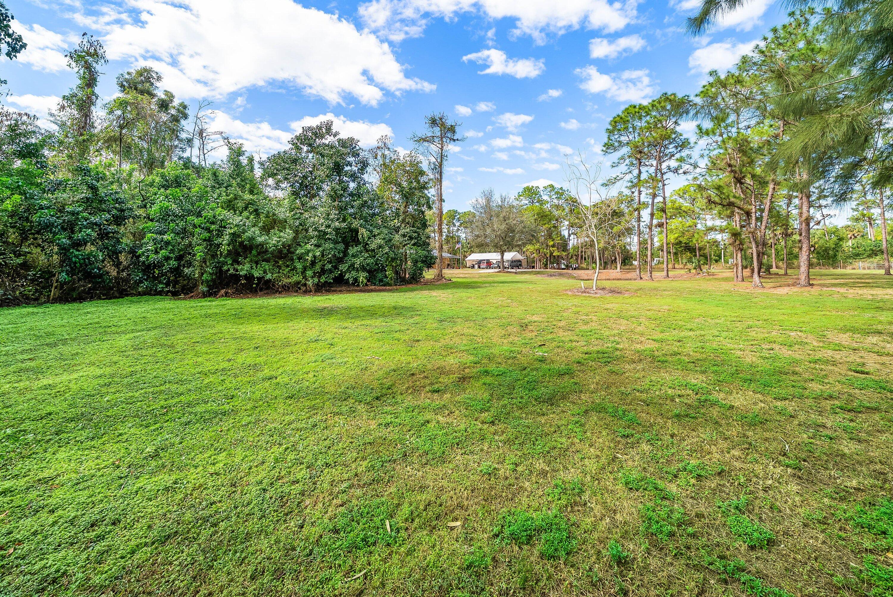 2195 F Road Loxahatchee Groves, FL 33470 - Photo 41 of 54 a view of a field with trees in the background