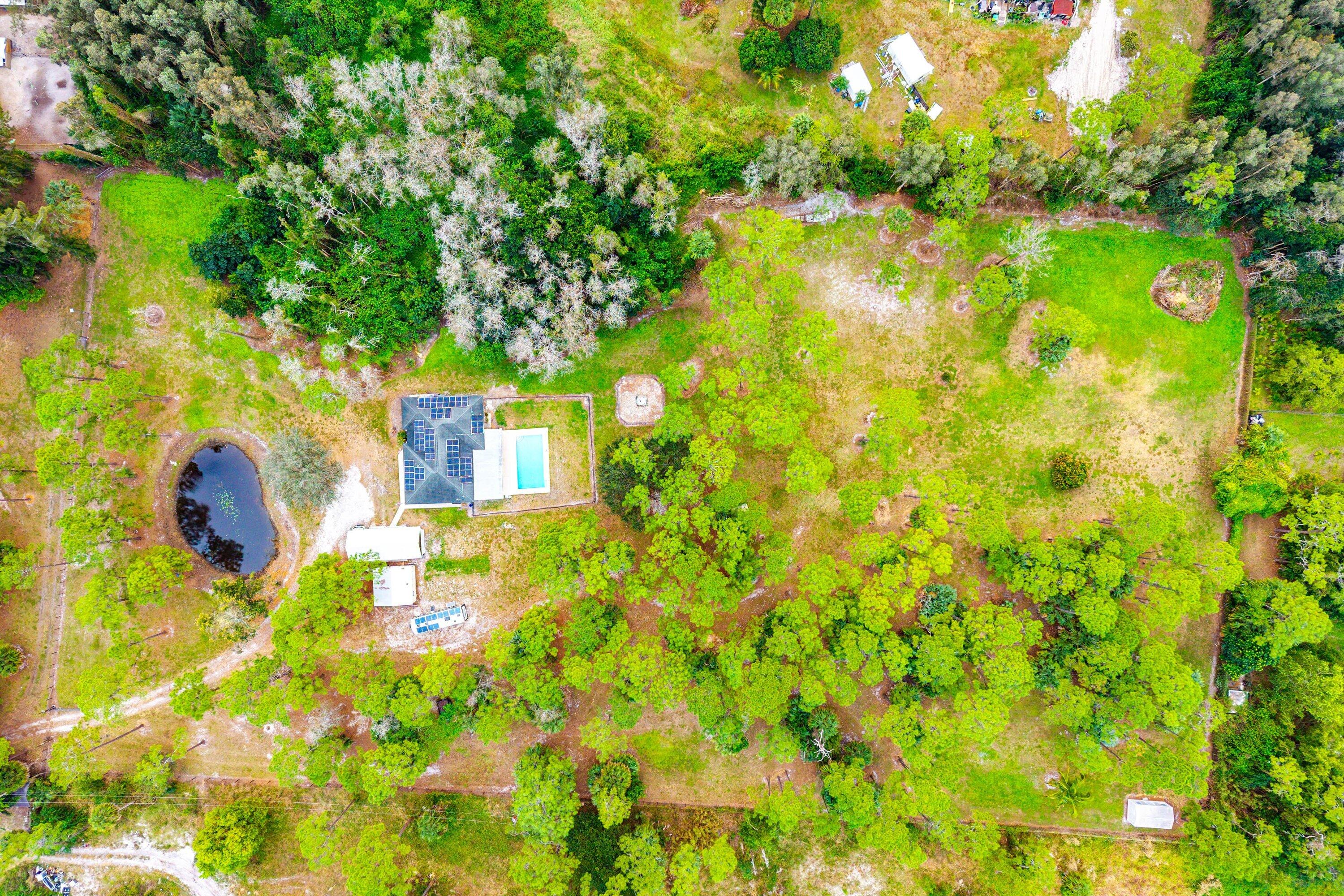2195 F Road Loxahatchee Groves, FL 33470 - Photo 46 of 54 a backyard of a house with large trees