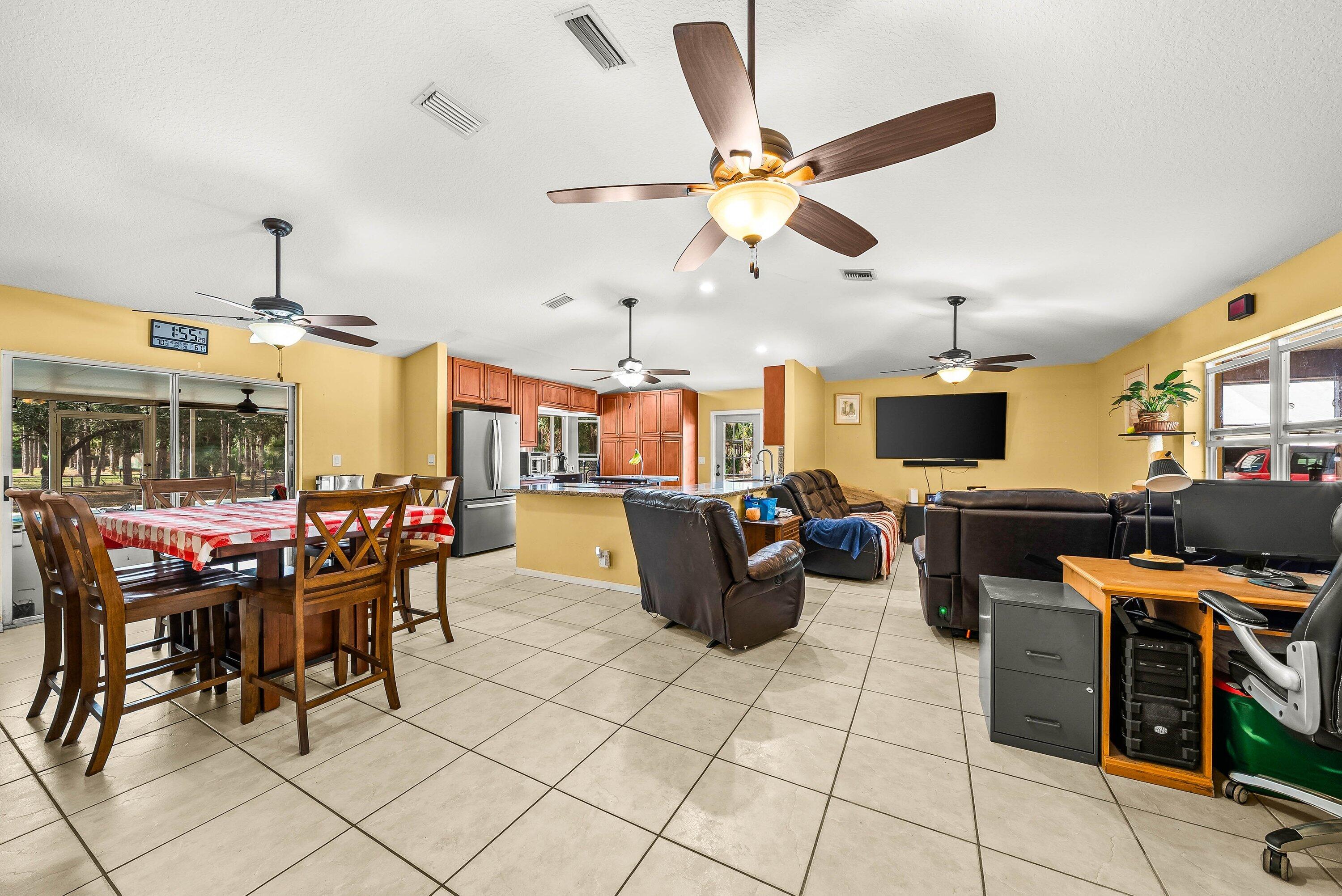 2195 F Road Loxahatchee Groves, FL 33470 - Photo 6 of 54 a view of a dining room with furniture