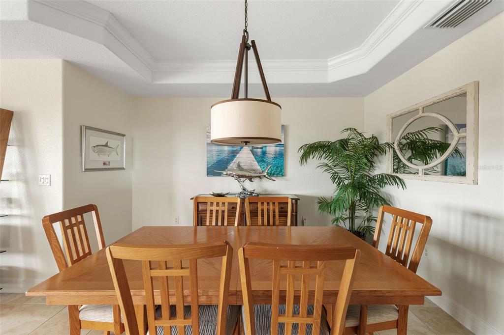 1420 Beach Road, Unit 204 Englewood, FL 34223 - Photo 14 of 99 a view of a dining room with furniture window and wooden floor