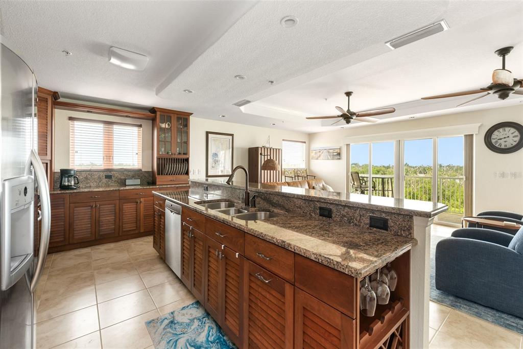 1420 Beach Road, Unit 204 Englewood, FL 34223 - Photo 17 of 99 a kitchen with stainless steel appliances granite countertop a stove and a sink