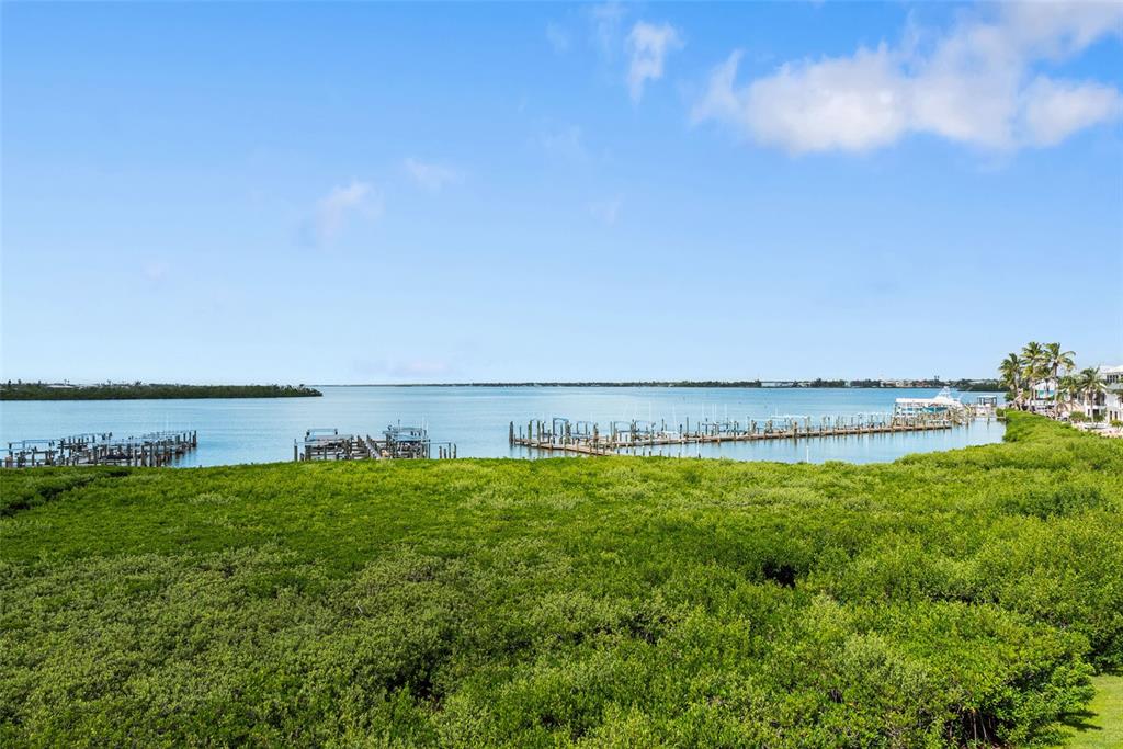 1420 Beach Road, Unit 204 Englewood, FL 34223 - Photo 34 of 99 a view of a large body of water with a house in the background