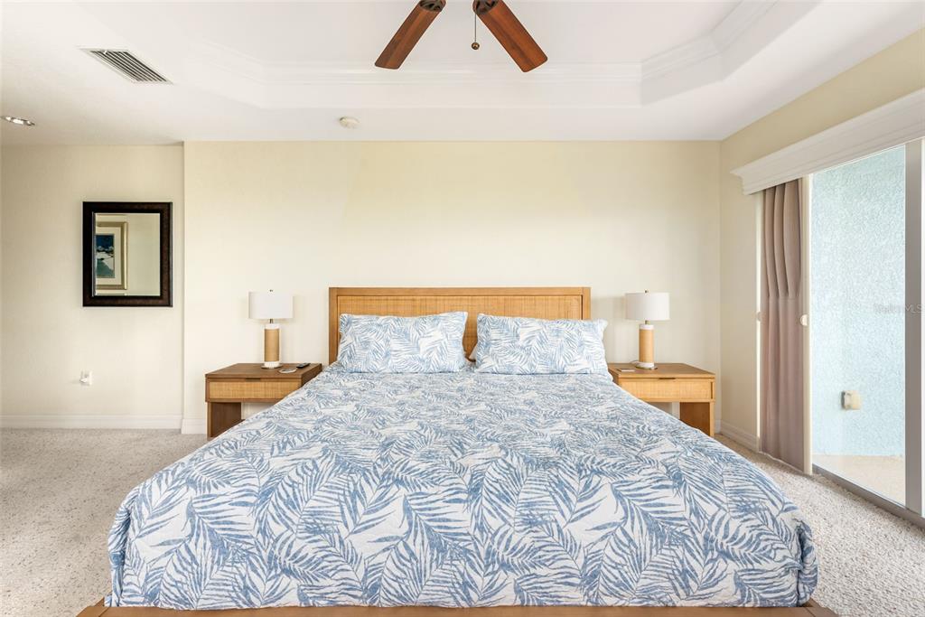 1420 Beach Road, Unit 204 Englewood, FL 34223 - Photo 42 of 99 a bedroom with a bed and a lamp on dresser