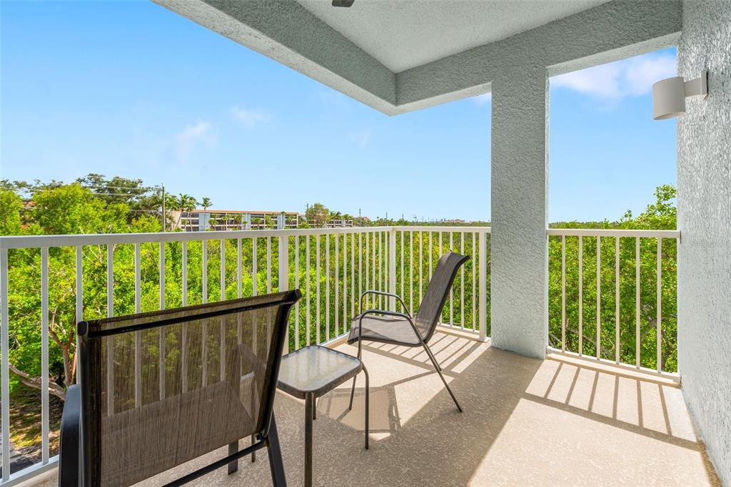 1420 Beach Road, Unit 204 Englewood, FL 34223 - Photo 43 of 99 a view of a chair and table in the balcony