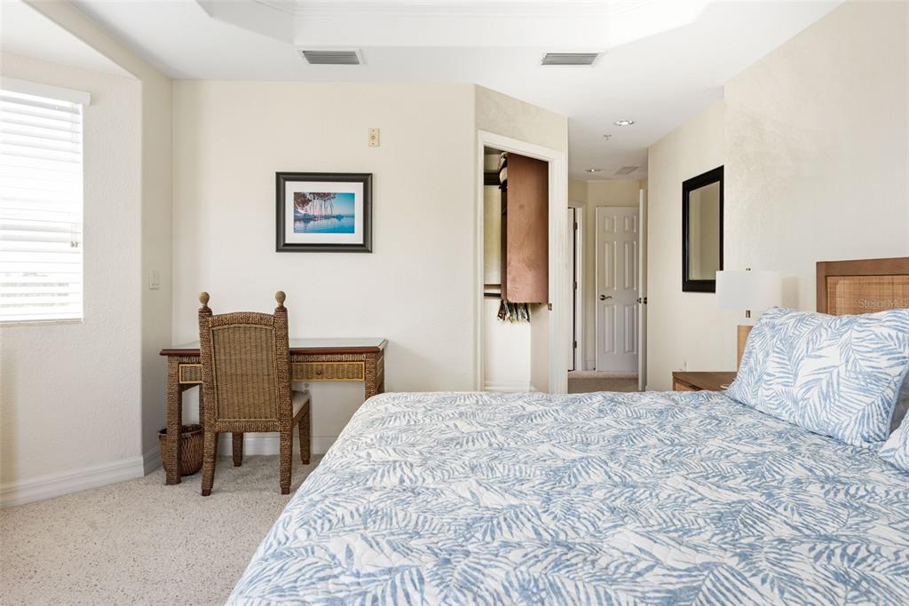 1420 Beach Road, Unit 204 Englewood, FL 34223 - Photo 44 of 99 a bedroom with a large bed and a desk