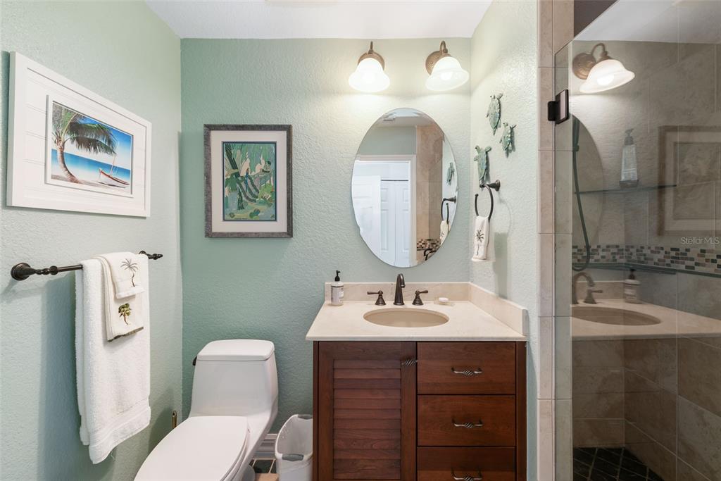 1420 Beach Road, Unit 204 Englewood, FL 34223 - Photo 48 of 99 a bathroom with a sink a toilet and a mirror