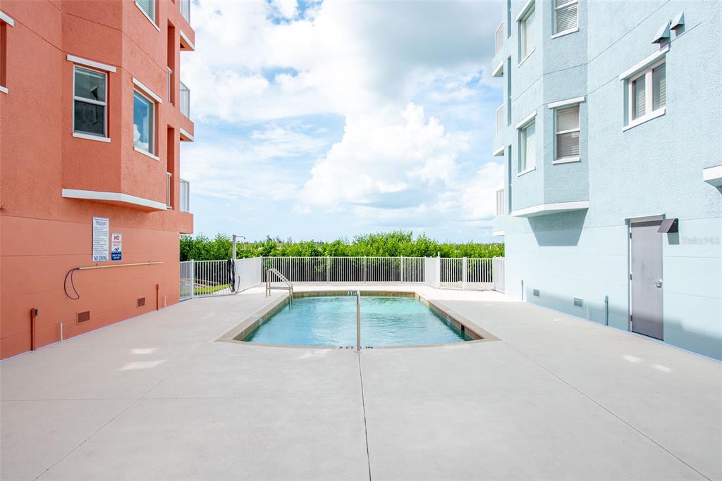 1420 Beach Road, Unit 204 Englewood, FL 34223 - Photo 55 of 99 a view of a swimming pool with a buildings