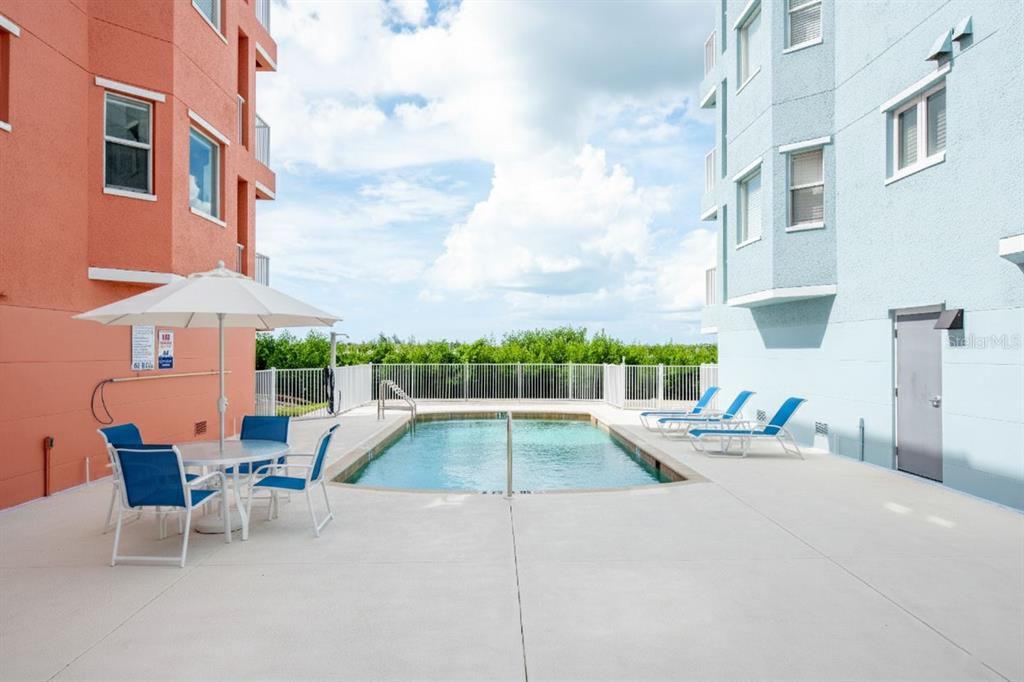 1420 Beach Road, Unit 204 Englewood, FL 34223 - Photo 9 of 99 a view of a patio with a table and chairs