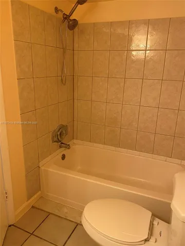a bathroom with a toilet and a bath tub