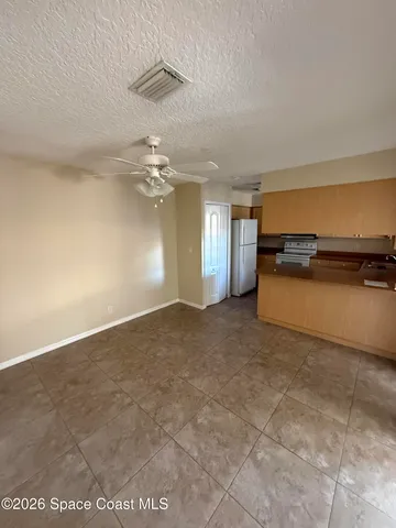 an empty room with a empty space and windows