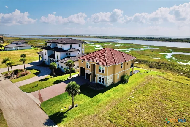 a view of a swimming pool with an ocean and trees in the background