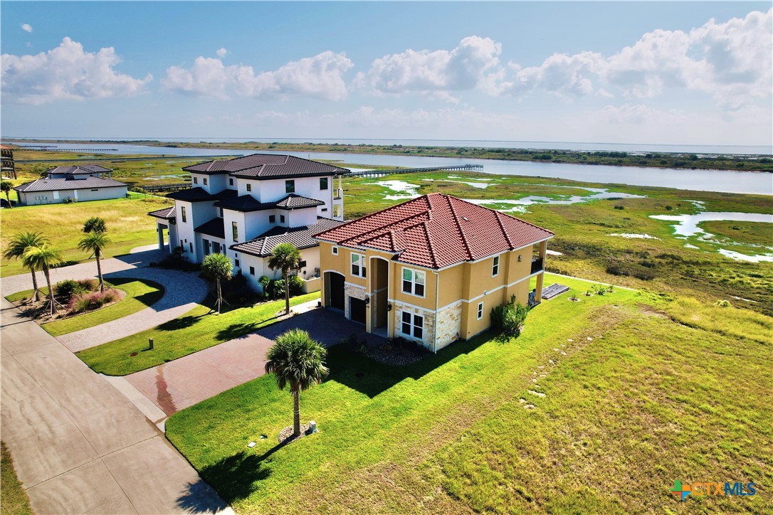 a view of a swimming pool with an ocean and trees in the background