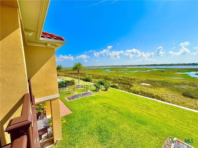 a view of an ocean pool patio and outdoor kitchen