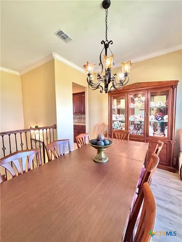 a view of a dining room with furniture and chandelier