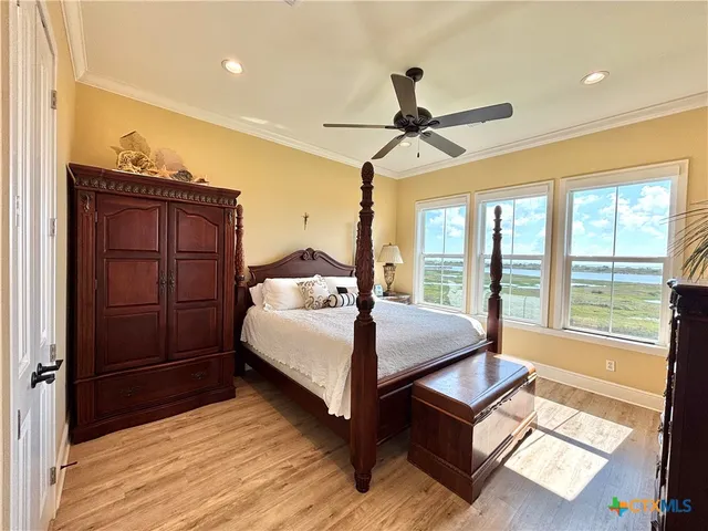 a bedroom with a bed and a flat tv screen on dresser