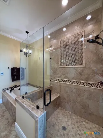 a bathroom with a tub sink shower and a mirror