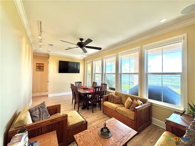 a view of a dining room with furniture window and wooden floor