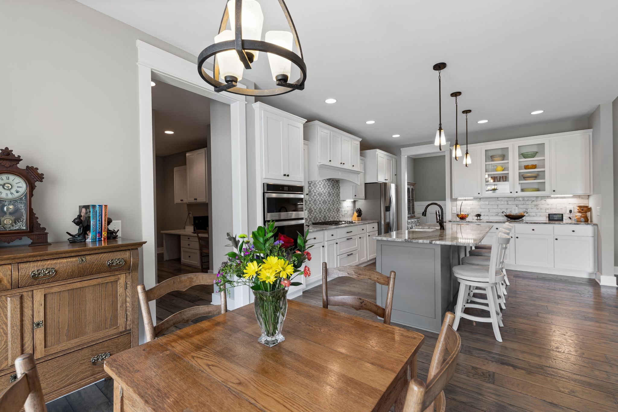 467 Halltown Road Portland, TN 37148 - Photo 15 of 33 a kitchen with stainless steel appliances kitchen island granite countertop a dining table chairs and white cabinets