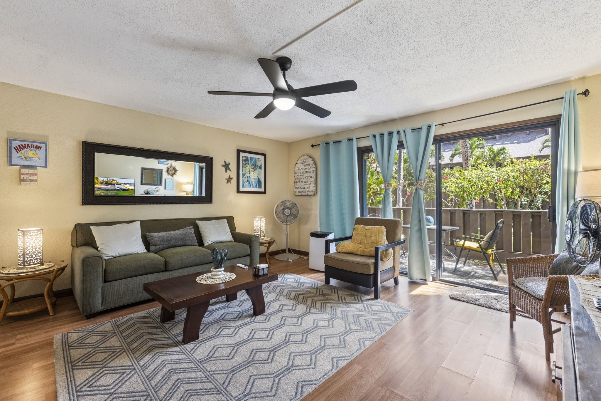 777 South Kihei Road, Unit 105 Kihei, HI 96753 - Photo 11 of 27 a living room with furniture and a large window