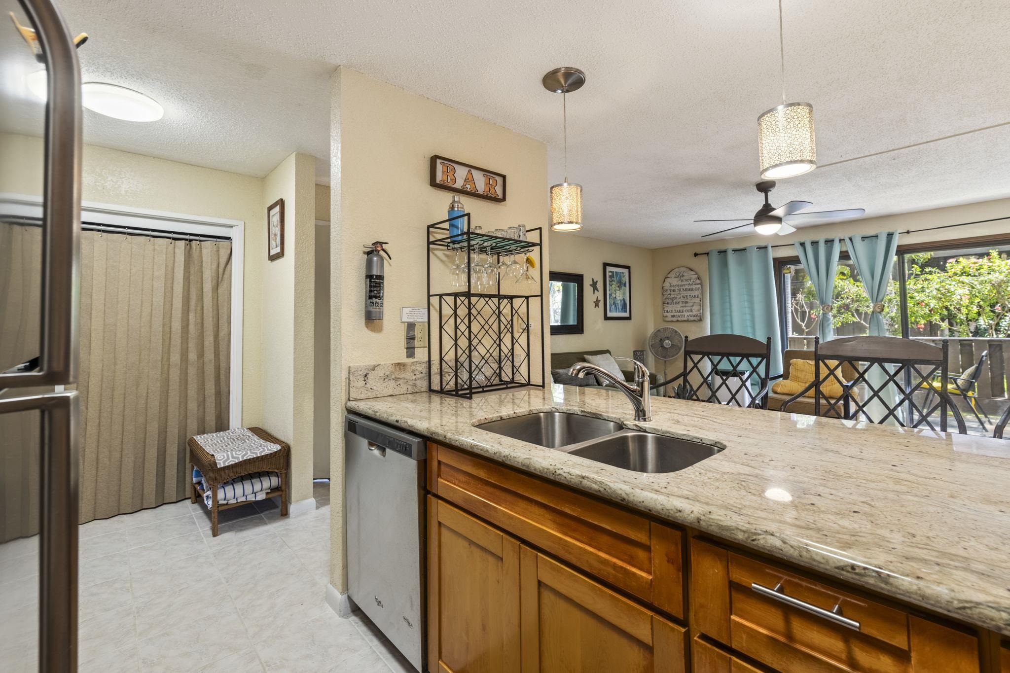777 South Kihei Road, Unit 105 Kihei, HI 96753 - Photo 13 of 27 a kitchen with sink refrigerator and window