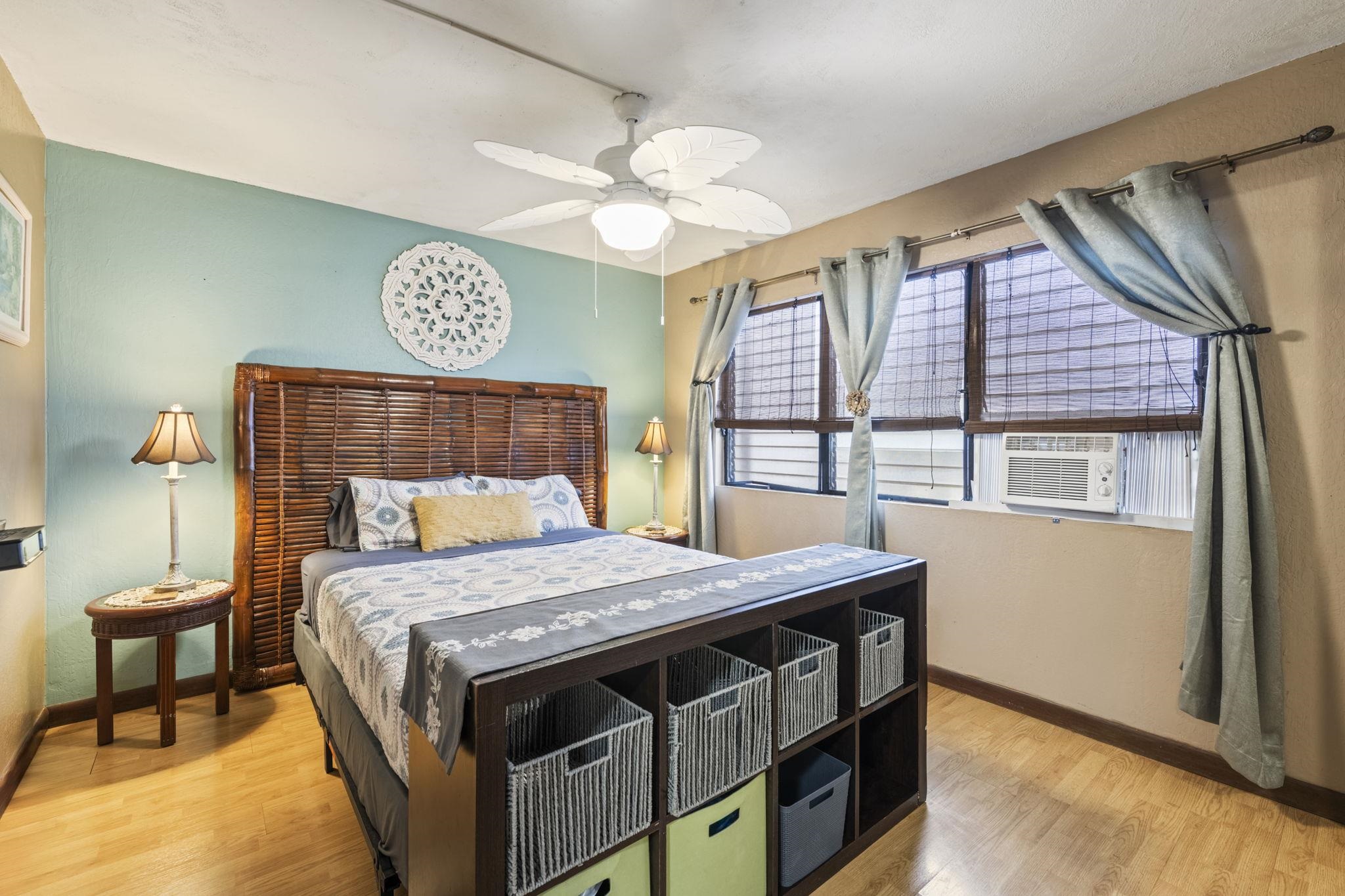 777 South Kihei Road, Unit 105 Kihei, HI 96753 - Photo 3 of 27 a bedroom with a bed and a table in it