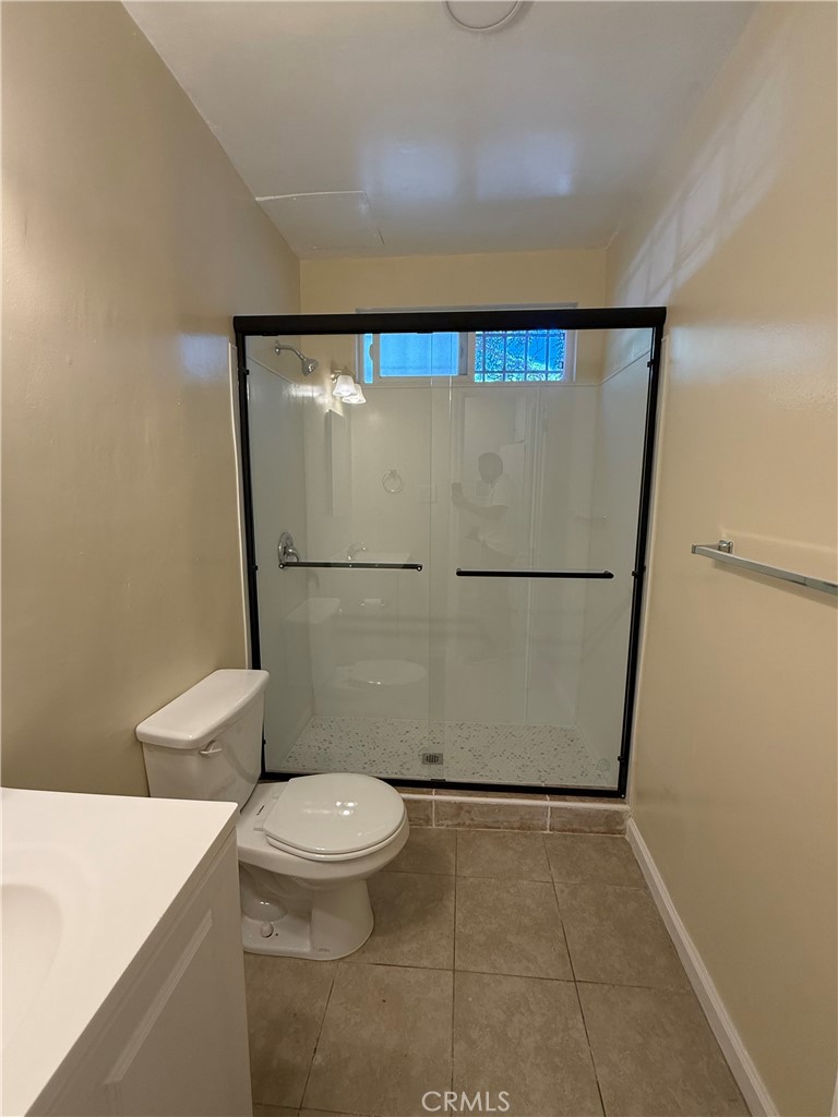 1805 South Rimpau Boulevard Los Angeles, CA 90019 - Photo 13 of 15 a bathroom with a granite countertop sink toilet and shower