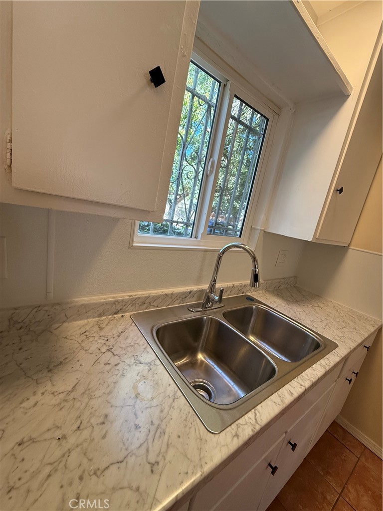 1805 South Rimpau Boulevard Los Angeles, CA 90019 - Photo 4 of 15 a close view of sink and tap
