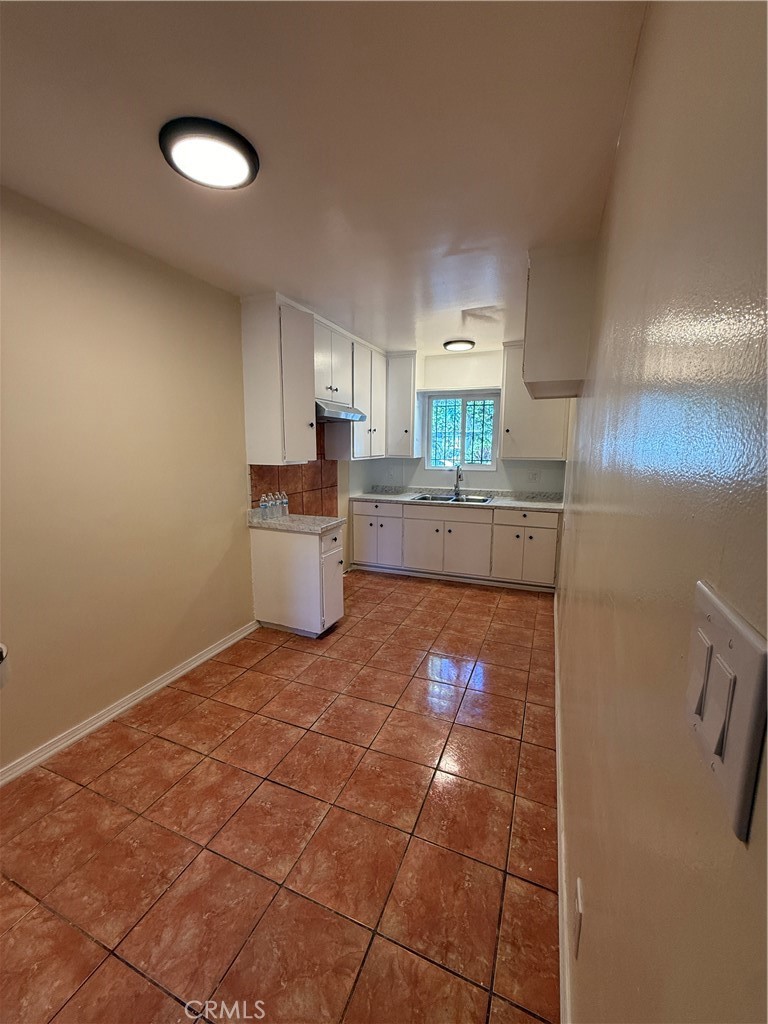 1805 South Rimpau Boulevard Los Angeles, CA 90019 - Photo 6 of 15 a kitchen with a sink a counter top space and appliances