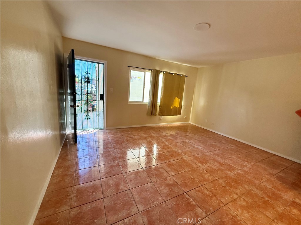 1805 South Rimpau Boulevard Los Angeles, CA 90019 - Photo 8 of 15 a view of an empty room with window and wooden floor