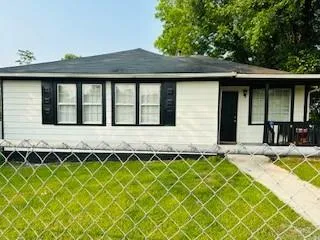 an outdoor view of a house with wooden fence