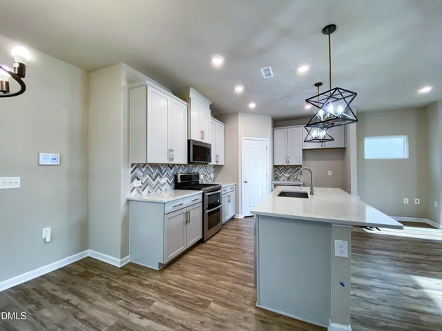 a view of an empty room with a fireplace and a window