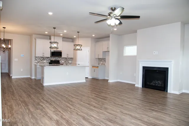a view of kitchen with refrigerator and wooden floor