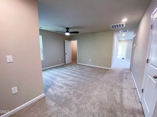 an empty room with closet and a window
