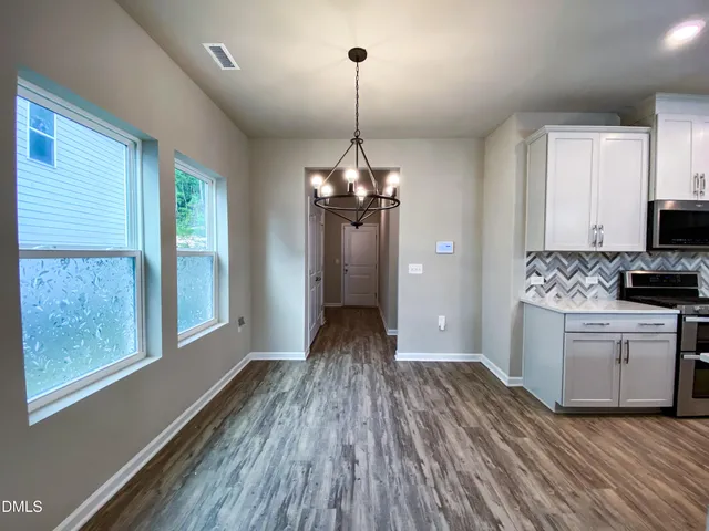 a view of a kitchen with a sink and a stove top oven