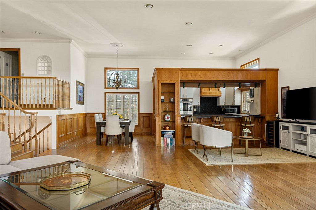 971 Grass Valley Road Lake Arrowhead, CA 92352 - Photo 23 of 50 a living room with furniture and a flat screen tv with kitchen view