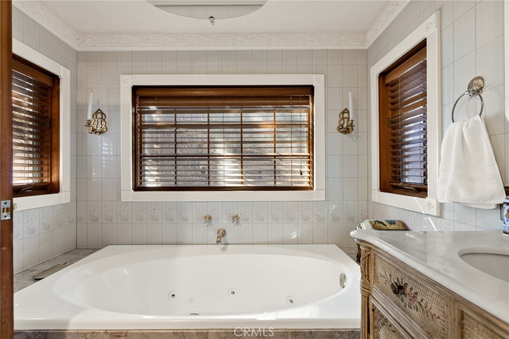 971 Grass Valley Road Lake Arrowhead, CA 92352 - Photo 37 of 50 a bathroom with a granite countertop sink and a bathtub