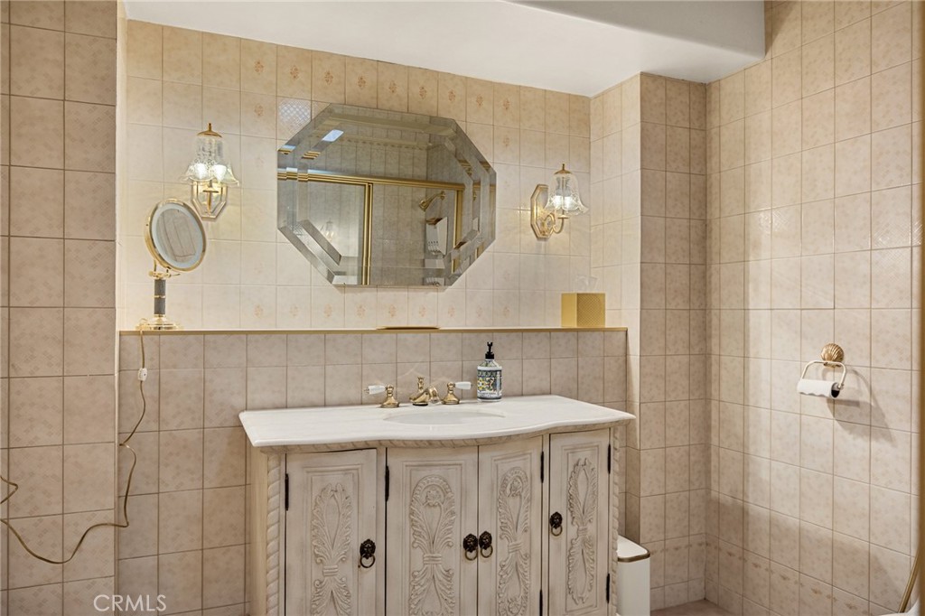971 Grass Valley Road Lake Arrowhead, CA 92352 - Photo 42 of 50 a bathroom with a sink vanity and a mirror