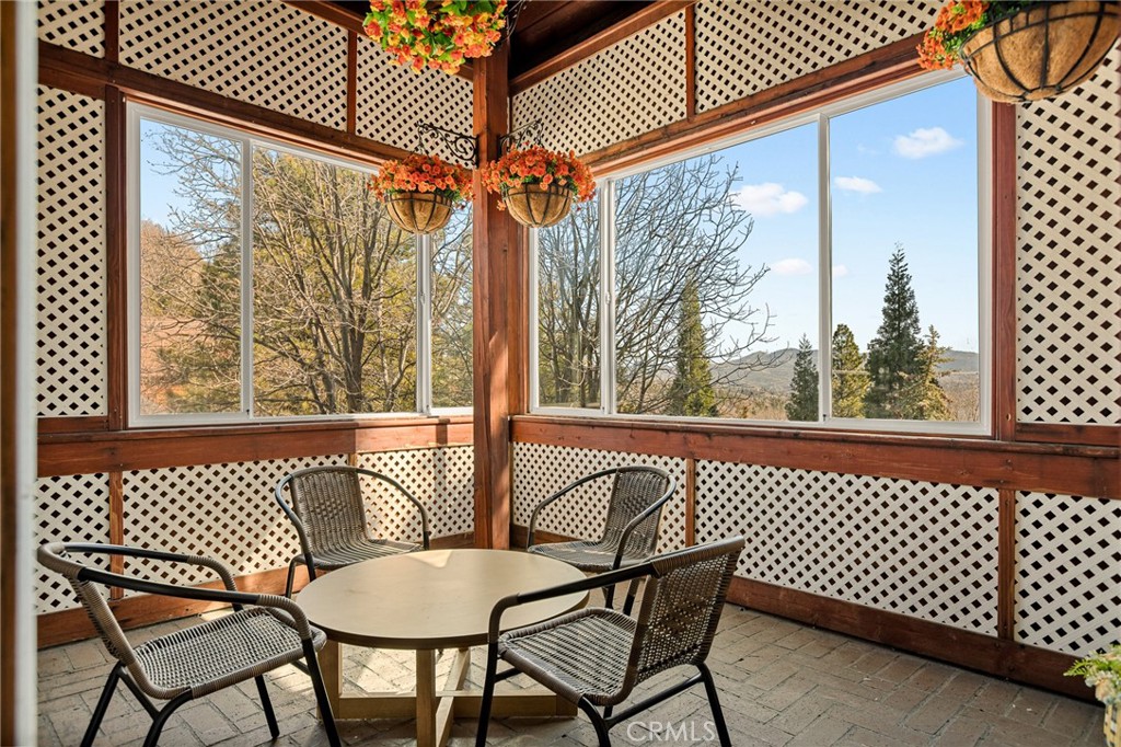 971 Grass Valley Road Lake Arrowhead, CA 92352 - Photo 8 of 50 a view of a chair and table in the balcony