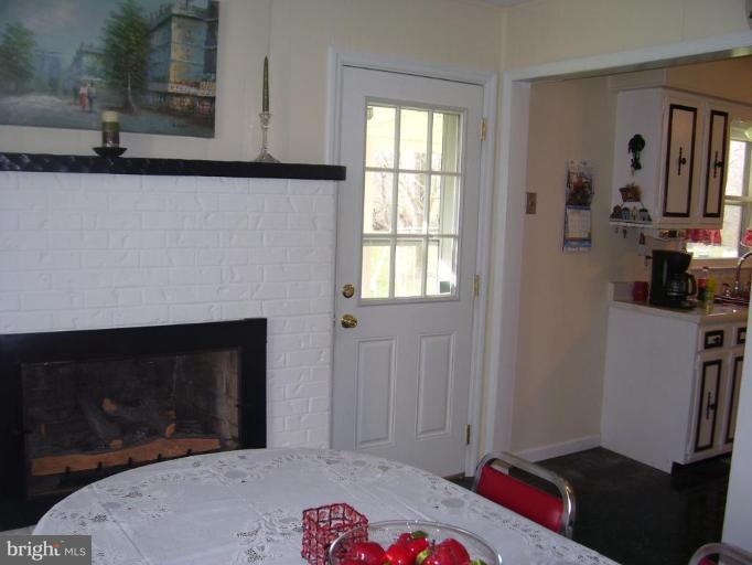 649 Kimble Road Berryville, VA 22611 - Photo 12 of 21 a living room with a fireplace furniture and a window