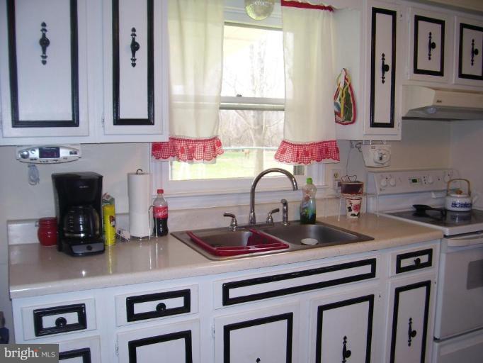 649 Kimble Road Berryville, VA 22611 - Photo 14 of 21 a kitchen with a sink cabinets and window