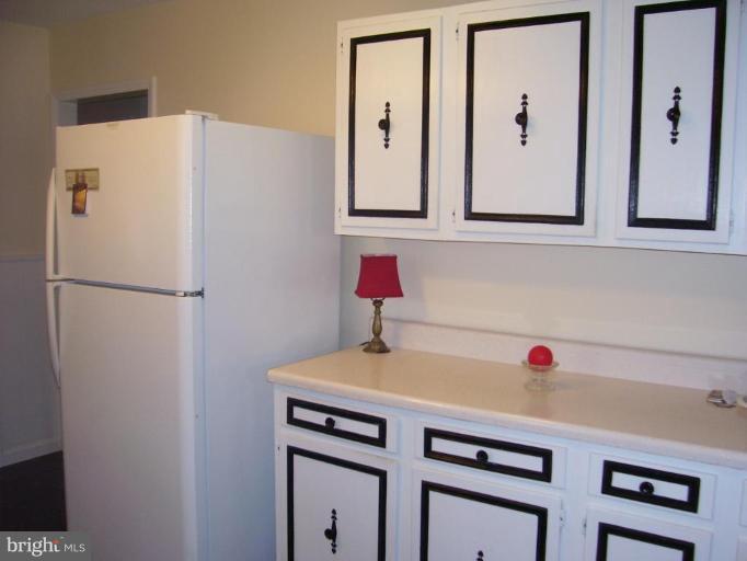 649 Kimble Road Berryville, VA 22611 - Photo 15 of 21 a white cabinet with a sink and cabinets