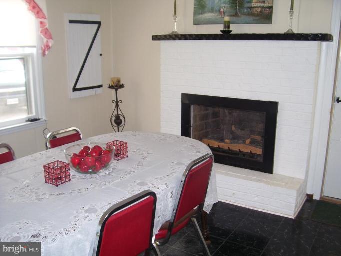 649 Kimble Road Berryville, VA 22611 - Photo 10 of 21 a bedroom with a bed and a fireplace
