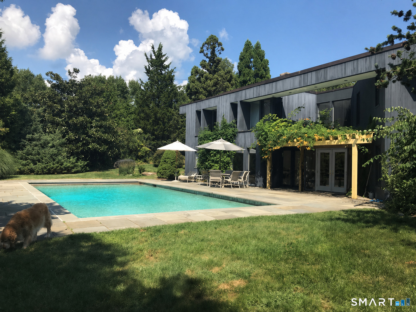 5 Longview Road Westport, CT 06880 - Photo 8 of 36 a front view of a house with swimming pool having outdoor seating