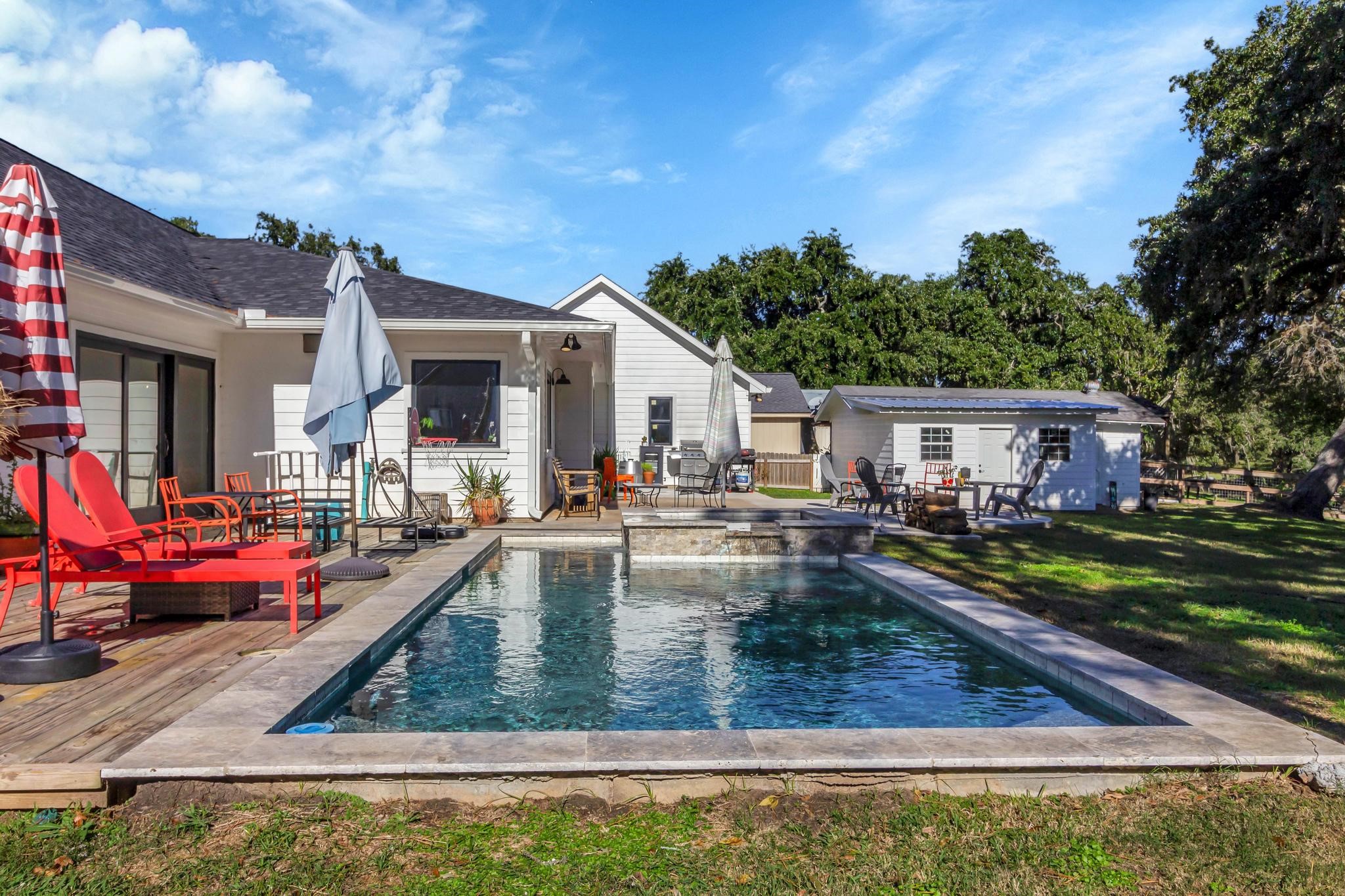 295 County Road 687 Angleton, TX 77515 - Photo 8 of 38 a view of a house with backyard swimming pool and sitting area