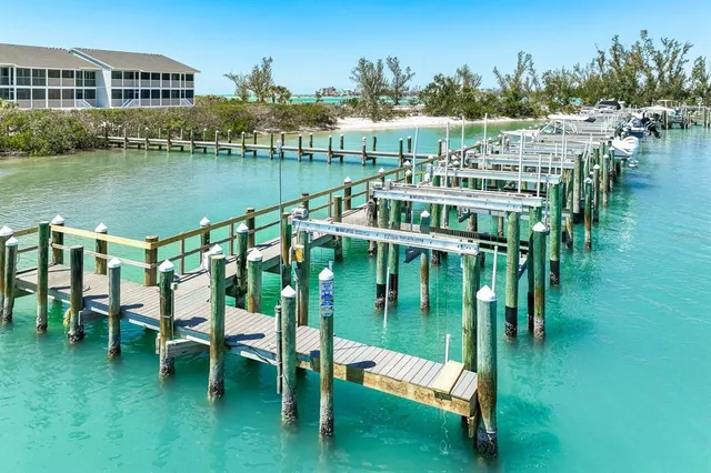 a balcony with chairs and lake view